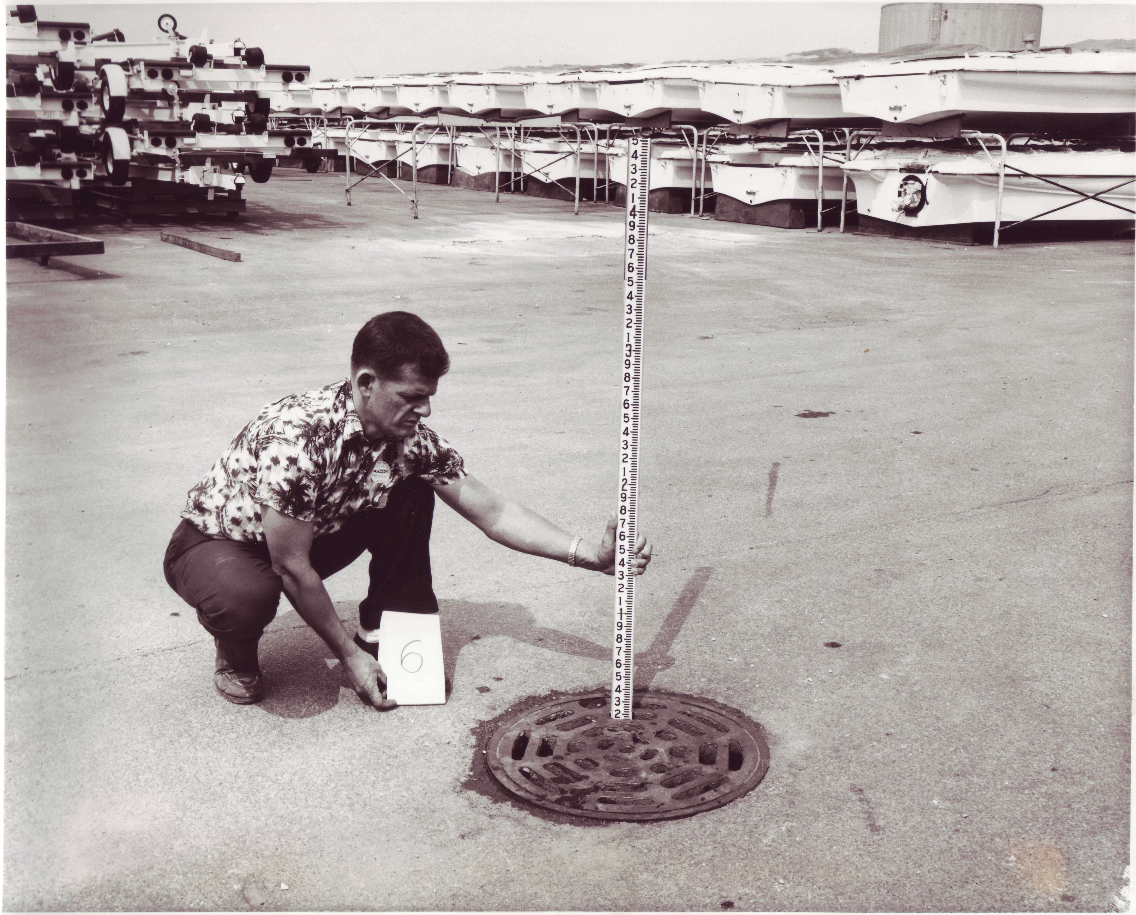 Jack Bleck measuring a drain